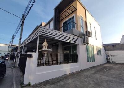 Modern two-story residential building with a covered patio