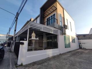 Modern two-story residential building with a covered patio