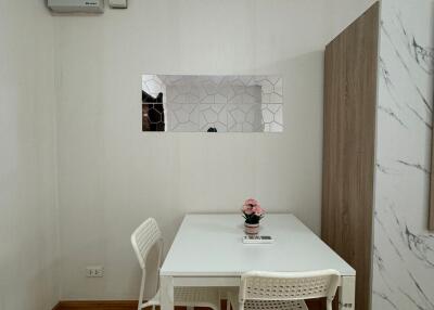 Compact dining area with a white table and two chairs