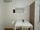 Compact dining area with a white table and two chairs