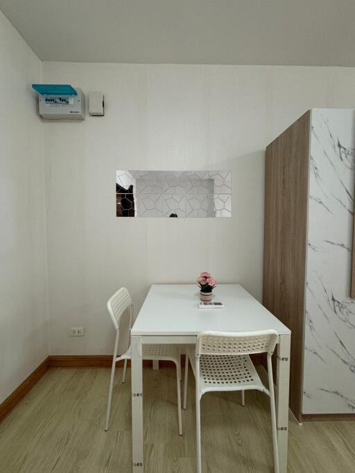 Compact dining area with a white table and two chairs