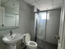 Modern bathroom with glass shower door and tiled walls