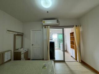 Bedroom with air conditioning, bed, and sliding door to balcony