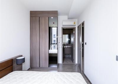 Modern bedroom with wooden wardrobe and ensuite bathroom