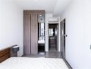 Modern bedroom with wooden wardrobe and ensuite bathroom