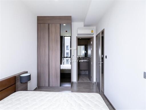 Modern bedroom with wooden wardrobe and ensuite bathroom