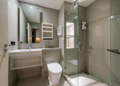 Modern bathroom with shower, sink, and toilet