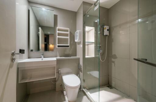 Modern bathroom with shower, sink, and toilet