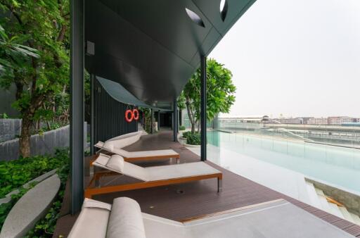 Modern outdoor lounging area with poolside view