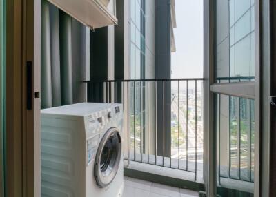 Laundry area with washing machine and expansive city view