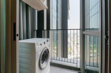 Laundry area with washing machine and expansive city view