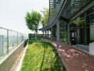 Modern building exterior with green rooftop garden and city view