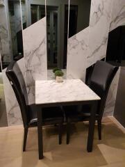 Small dining table with two chairs in a modern decor