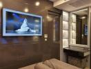 Modern bedroom with wall-mounted TV and vanity mirror