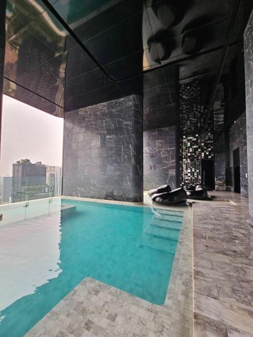 Indoor swimming pool with lounge chairs