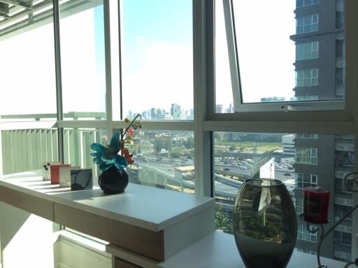 Bright living area with large windows and city view