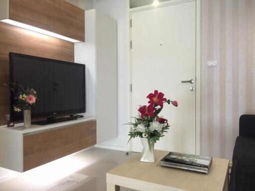 Modern living room with TV and flower decorations