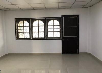 Empty room with tiled floor and metal windows