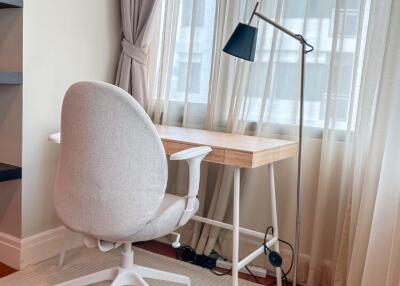 Bright home office with desk, chair, and floor lamp