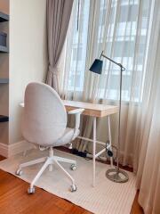 Bright home office with desk, chair, and floor lamp