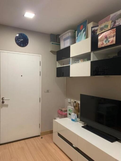 Well-organized modern living room with wall-mounted shelves and a TV console