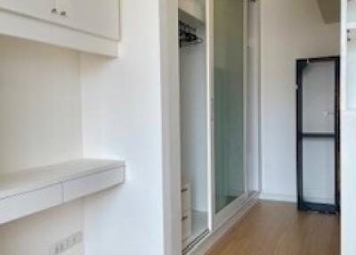 Modern hallway with built-in storage and wooden flooring