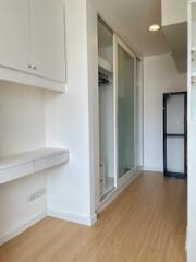 Modern hallway with built-in storage and wooden flooring