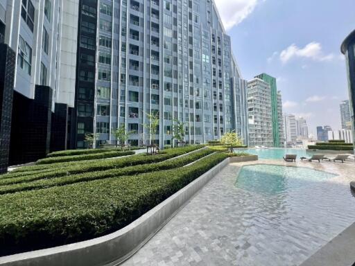 Modern high-rise building with a landscaped courtyard and swimming pool