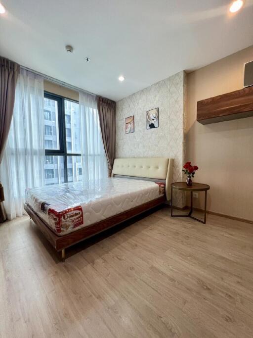 Modern bedroom with large window and natural light