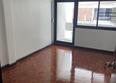 Empty bedroom with large window and air conditioning unit