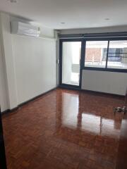 Empty bedroom with large window and air conditioning unit