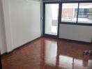 Empty bedroom with large window and air conditioning unit