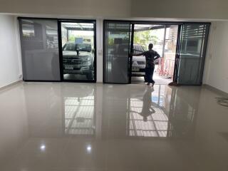 Garage with two cars and large glass doors