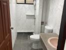 Modern bathroom with marble walls and gray floor tiles