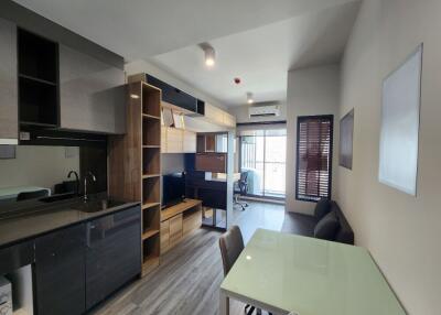 Modern and functional living area with kitchen and workspace