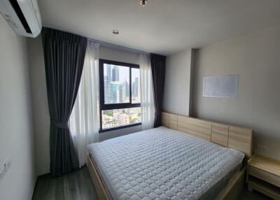 Bedroom with large window and city view