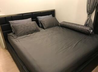 Modern bedroom with black bed frame and grey bedding