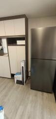 Modern kitchen with refrigerator and storage cabinets