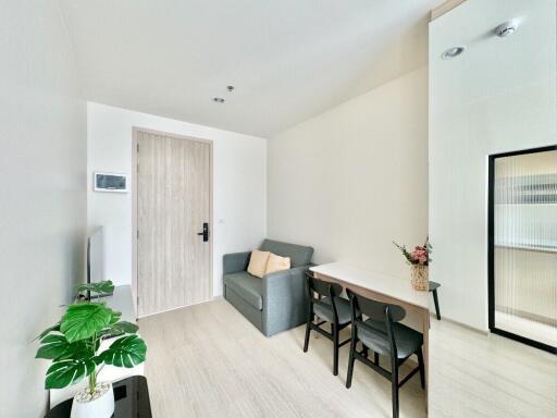 Bright and modern living room with sofa and dining area