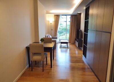 Modern living room with hardwood floor and ample natural light