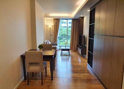 Modern living area with large window and wooden flooring