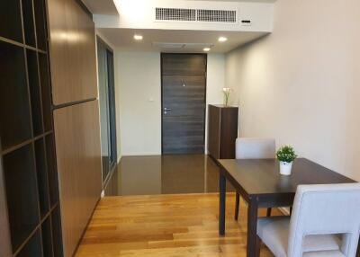 Cozy dining area with a modern table and chairs, and a door in the background