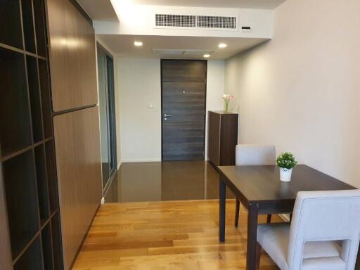 Cozy dining area with a modern table and chairs, and a door in the background