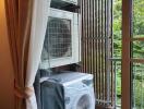 Balcony view with air conditioning unit and washing machine