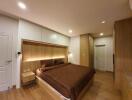 Modern bedroom with wooden flooring and ambient lighting