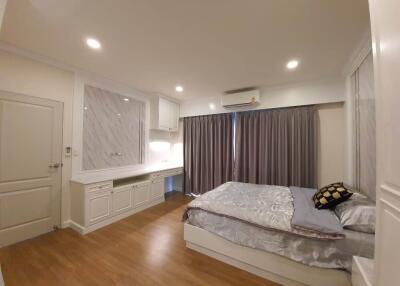 Spacious bedroom with natural lighting and modern furnishings