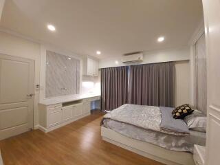 Spacious bedroom with natural lighting and modern furnishings