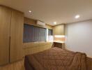 Bedroom with wooden furniture and brown bedspread