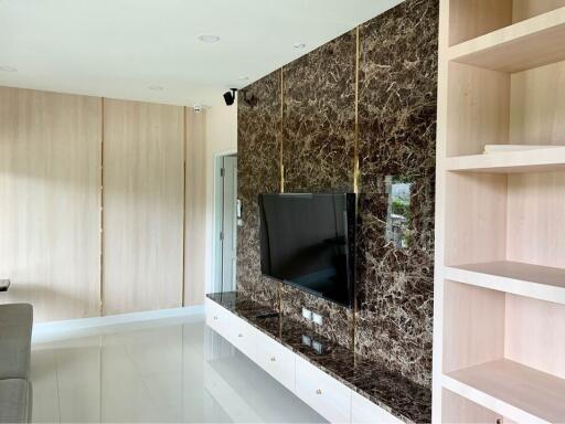 Modern living room with marble wall and TV