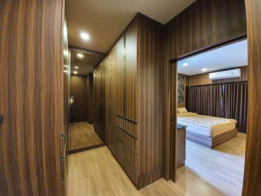 Spacious bedroom with a wooden theme and ample storage space